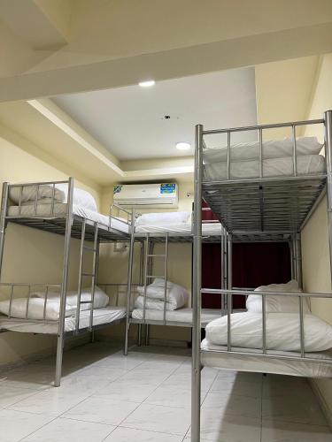 a room with three bunk beds in it at United Holiday Homes in Dubai