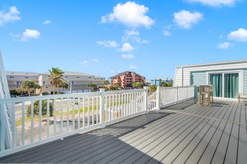 a deck with a view of the beach and buildings at Boardwalk Unit A4 in Pensacola Beach