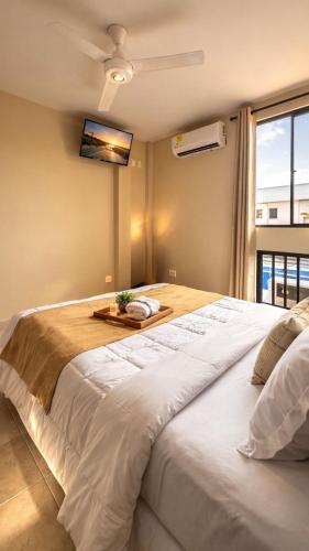 a large white bed in a room with a window at Operadora Stay - Edificio Puerto Living in Barrancabermeja