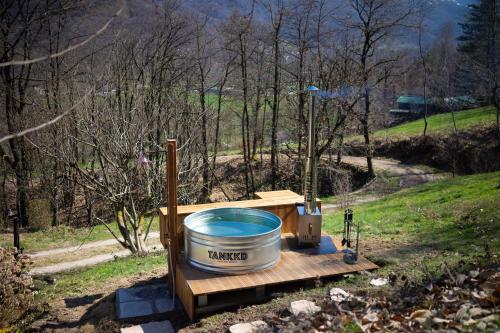a large bucket of water sitting on a wooden table at Materin in Roccaforte Mondovì
