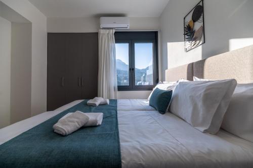 a bedroom with a large bed with two pillows on it at AORA Asites Mountain View in Kato Asites