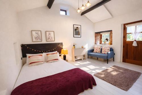 a bedroom with a large bed and a blue chair at Little Gem at Lough Sillan House - Adults only in Shercock