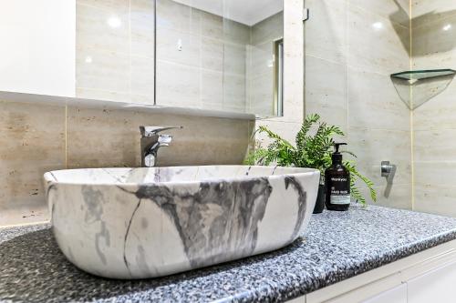 a bathroom with a large marble sink on a counter at Relax Refresh Rejuvenate Pool Cabin Garden Tree house Vintage charm in Berwick