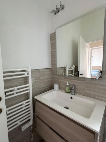 a bathroom with a white sink and a mirror at Villa sul mare di Cupra in Cupra Marittima