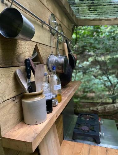 a wooden counter with cooking utensils and a pot on it at Esk Yurt in Drummelzier