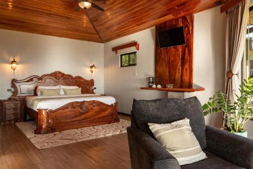 a bedroom with a bed and a couch at Hotel Trópico Monteverde in Monteverde Costa Rica