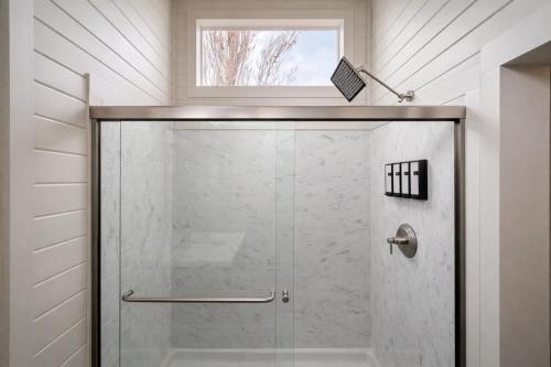 a shower with a glass door in a bathroom at Ultra Luxury Tiny Home with Deck in Page