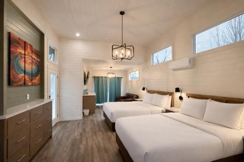a hotel room with two beds and a tv at Ultra Luxury Tiny Home with Deck in Page