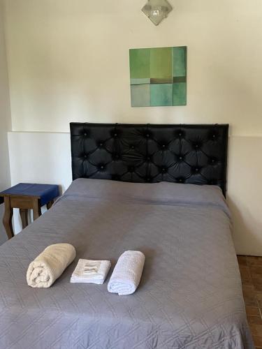a bedroom with a bed with two towels on it at CASONA Malva del Rio in Villa Carlos Paz