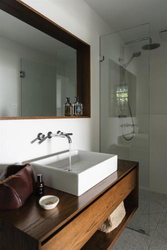 a bathroom with a white sink and a shower at Bay Properties Bridgewood in Yamba