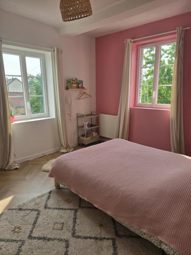 a bedroom with a bed and two windows at La Hacienda Verde in Heudreville-sur-Eure