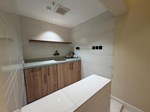 a kitchen with wooden cabinets and a sink at فندق ستل أوشن in Jazan