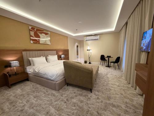a hotel room with a bed and a couch at فندق ستل أوشن in Jazan
