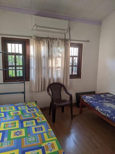 a room with two beds and a chair in it at Stay in flying in Katunayaka