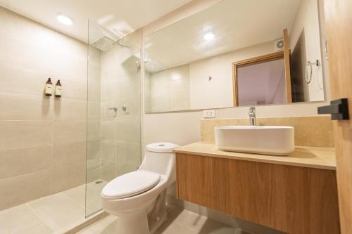a bathroom with a toilet and a sink and a shower at Alcaré Rooms Cartagena in Cartagena de Indias