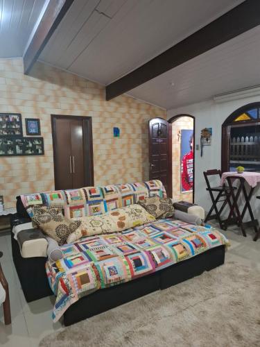 a bedroom with a large bed and a table at Casas do Pescador in Maricá