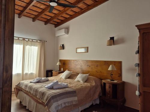 a bedroom with a bed with two towels on it at Casa Nido San Javier in San Javier