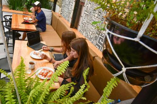 two girls sitting at a table in a restaurant at 13 Cielos Hostel & Coworking in San Cristóbal de Las Casas