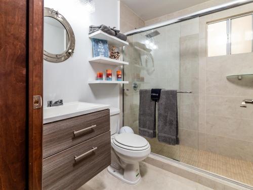 a bathroom with a toilet and a shower at Ocean View, Amazing Sunsets, AC, Pool in Tijuana