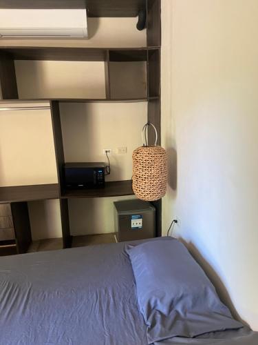 a bedroom with a bed and a book shelf at Mango Soul in El Zonte