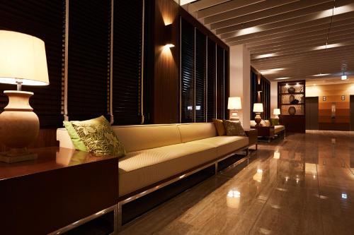 a living room with a couch and a table at Hotel Forza Nagasaki in Nagasaki