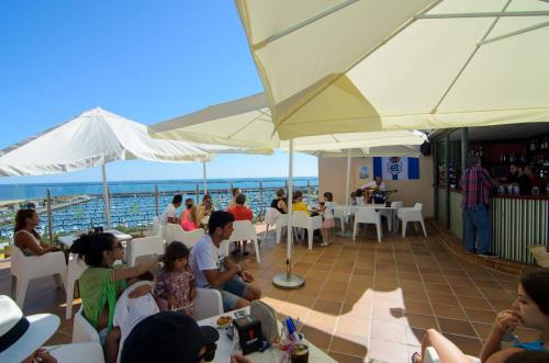 a group of people sitting in a restaurant at Hotel Apartamento Martín Alonso Pinzón in Mazagón