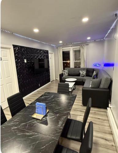 a living room with a table and a couch at EWRBNB- Private bedroom in a Well Spaced Shared Apartment 4 in Elizabeth
