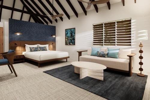 a bedroom with a bed and a bed and a couch at Tropica Island Resort-Adults Only in Malolo
