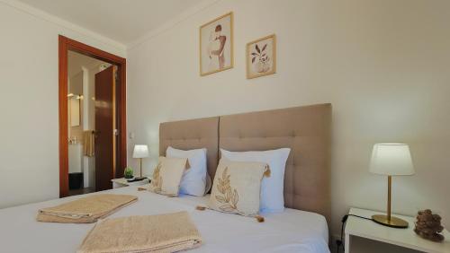 a bedroom with a bed with two towels on it at Baleal Beach Stay in Baleal