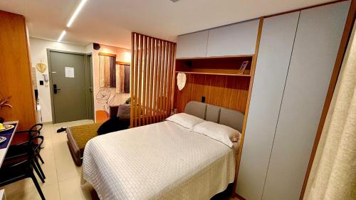 a bedroom with a white bed in a room at Flat com acesso rápido as praias e o melhor do turismo local in João Pessoa