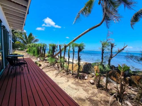 a porch of a house with a view of the beach at Toreaiva 91 Beachfront Studios in Arorangi