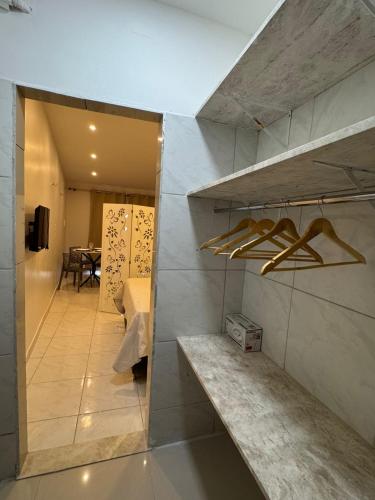 a room with a hallway with a table and a shelf at Casa aconchego do pontal in Fortim