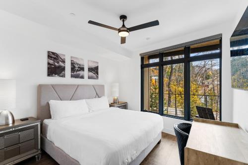 a bedroom with a white bed and a window at Apres Shores #C13 in Silverthorne