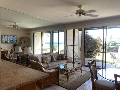 a living room with a couch and a table at Napili Point Oceanfront Turtle View 1BR - Unit B30 condo in Lahaina