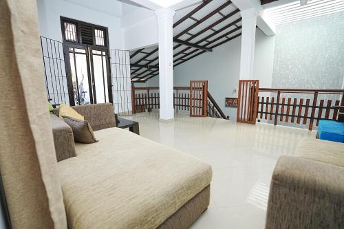 a room with a bed and chairs in it at lumiere south Residence in Matara