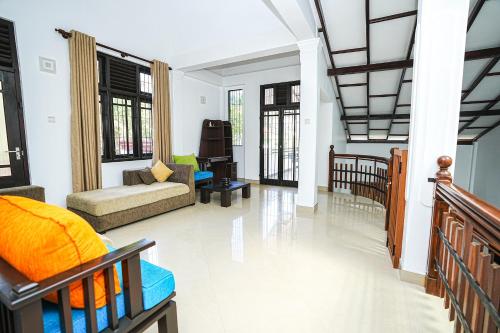 a living room with a couch and a piano at lumiere south Residence in Matara