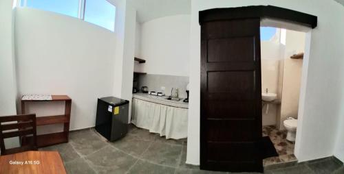 a bathroom with a sink and a toilet in a room at Pescadito in Puerto Ayora