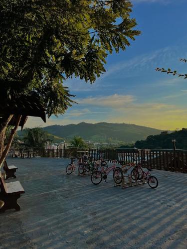 a group of bikes parked next to a bench at Pousada Pé da Serra in Lindóia