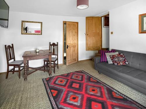a living room with a couch and a table at Sunnyside in Yoxford