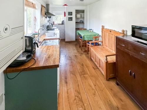 a kitchen with a wooden counter top in a room at Sunnyside in Yoxford