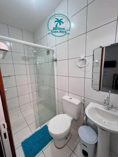 a bathroom with a toilet and a shower and a sink at Casa Maré in Aracati