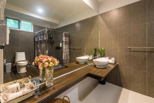 a bathroom with two sinks on a wooden counter at Siya Private Pool Villa Ao Nang in Ao Nang Beach