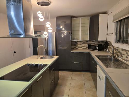 a kitchen with a sink and a counter top at Brossard home2 in Brossard