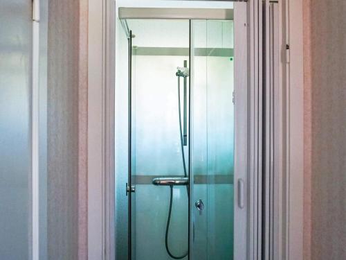 a shower with a glass door in a bathroom at Comfortable Apartment Near Stenungsund in Munkedal