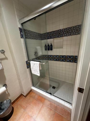 a shower with a glass door in a bathroom at La Paloma in Rosarito Beach
