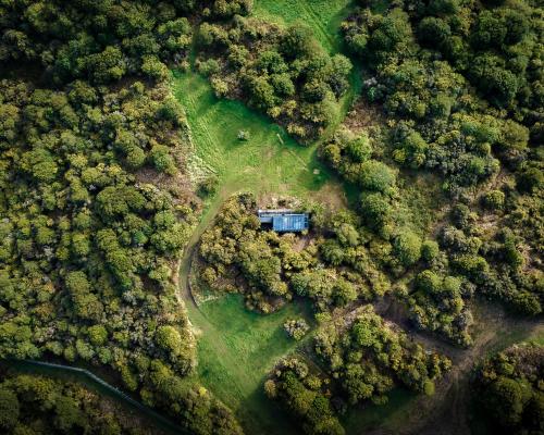 an aerial view of a house in the middle of a forest at Tokoeka PurePod in Stewart Island