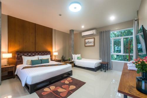 a hotel room with two beds and a window at Siya Private Pool Villa Ao Nang in Ao Nang Beach