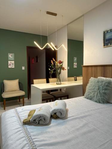 a bedroom with a bed with two towels on it at Flat JK 203 in Juazeiro do Norte