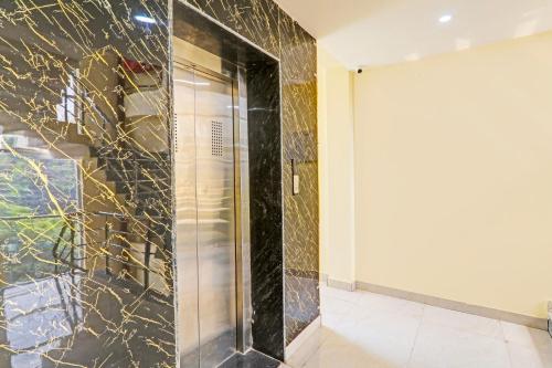 a shower with a glass door in a room at Super Hotel O Kathauta Jheel Malhaur Gomti Nagar in Lucknow
