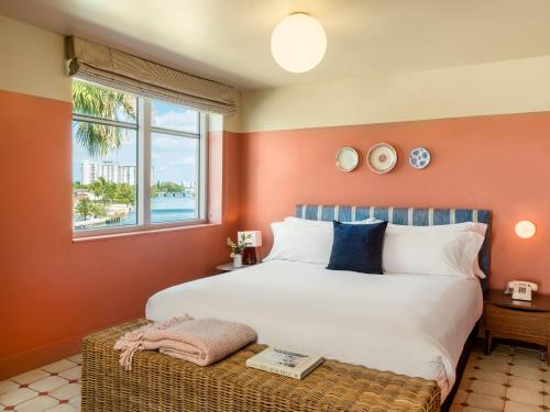 a bedroom with a large bed and a window at Hotel Trouvail Miami Beach in Miami Beach